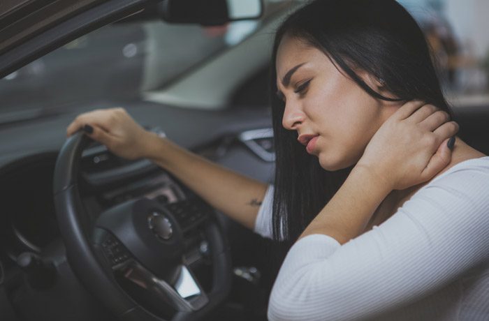 Woman-touching-neck-in-pain-from-whiplash-caused-by-car-accident