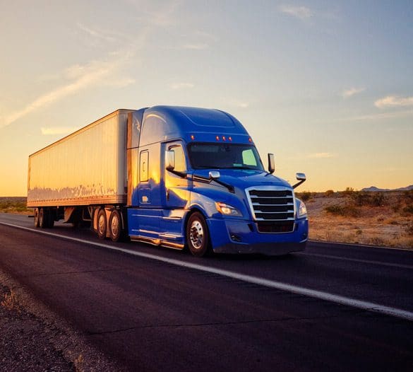 Semi-truck-on-a-highway-near-sunset Semi-truck-on-a-highway-near-sunset