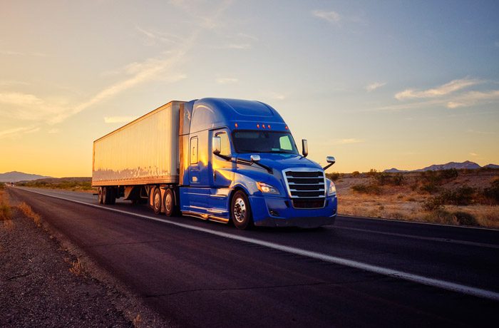 Semi-truck-on-a-highway-near-sunset