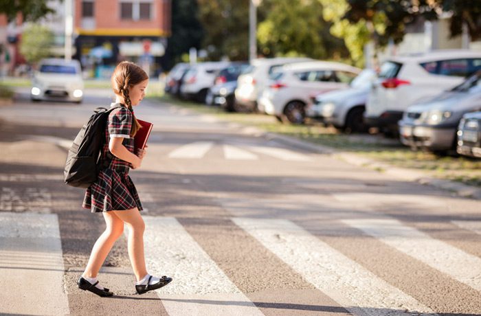 Girl-crossing-the-street-on-her-way-to-school