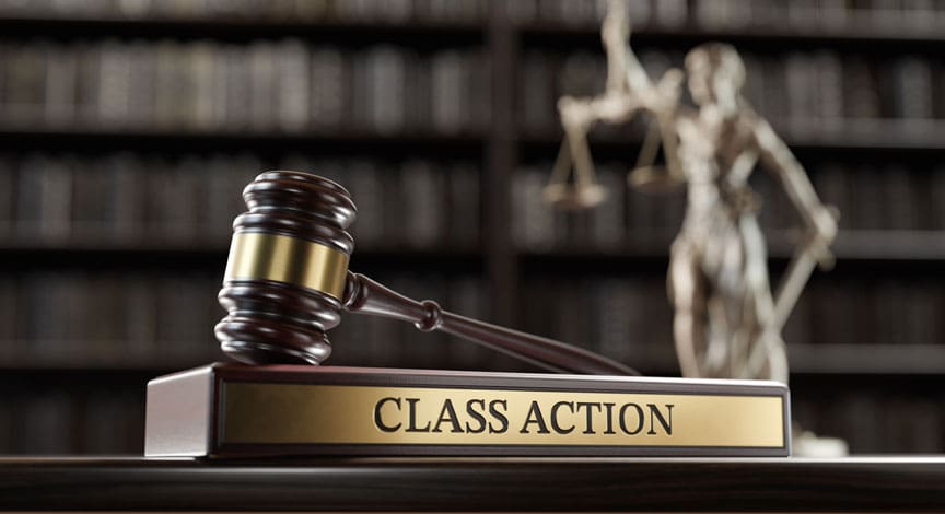 gavel-on-a-class-action-nameplate-in-front-of-a-bookshelf