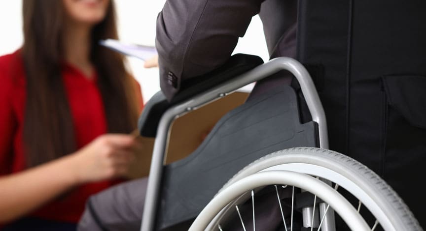 woman-in-a-wheelchair-talking-with-someone-in-an-office